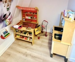 Houten speelwinkel met een IKEA keuken en accessoires.